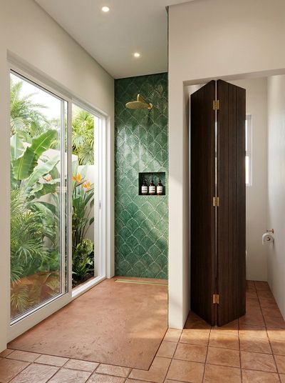 A garden shower finished in palm-leaf tilework.